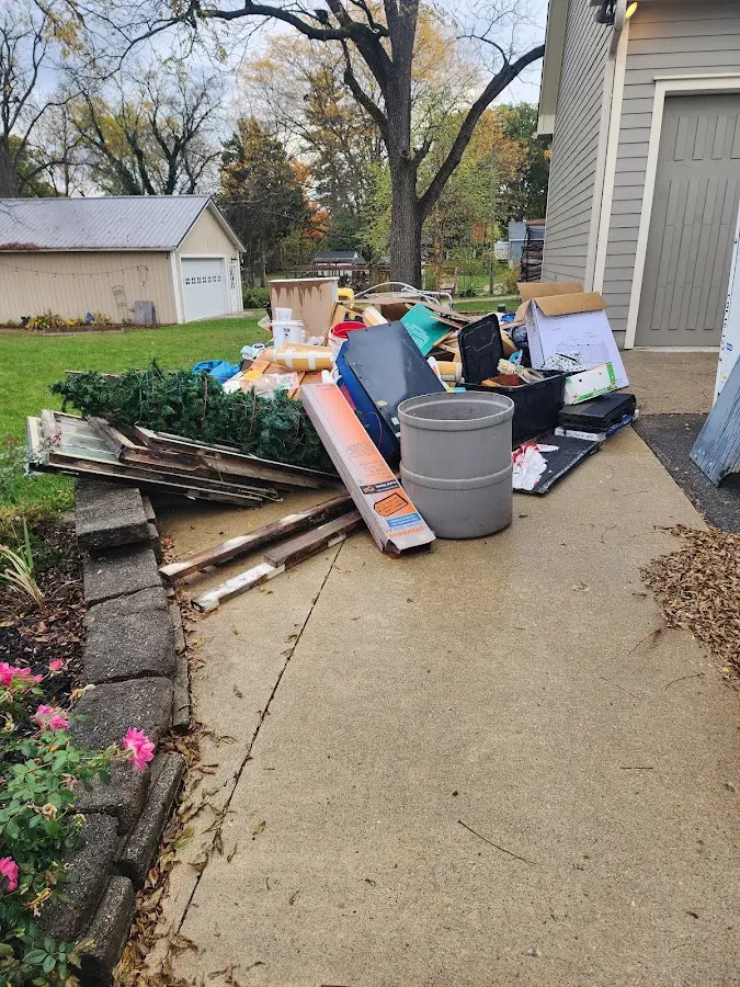 Dumpster being loaded with debris for 12 Yard Dumpster Rental in Waverly